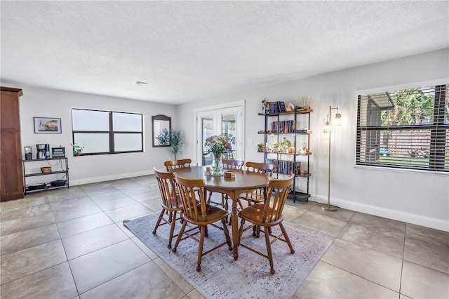 4821 S Gachet Blvd, Lakeland, FL 33813 - dining space featuring plenty of natural light, a textured ceiling, baseboards, and light tile patterned flooring