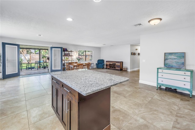 4821 S Gachet Blvd, Lakeland, FL 33813 - kitchen featuring plenty of natural light, open floor plan, light stone countertops, recessed lighting, and a textured ceiling