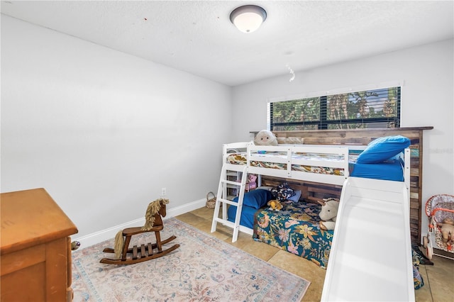 4821 S Gachet Blvd, Lakeland, FL 33813 - bedroom with a textured ceiling and baseboards