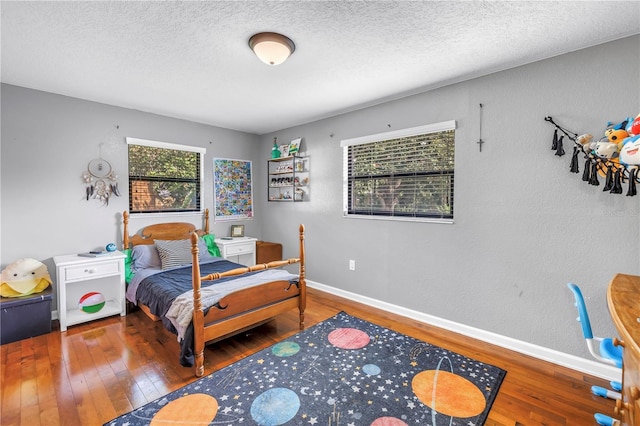 4821 S Gachet Blvd, Lakeland, FL 33813 - bedroom featuring hardwood / wood-style flooring, a textured ceiling, and baseboards