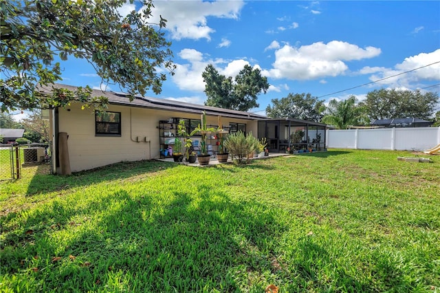 4821 S Gachet Blvd, Lakeland, FL 33813 - back of house with a sunroom, a gate, and solar panels
