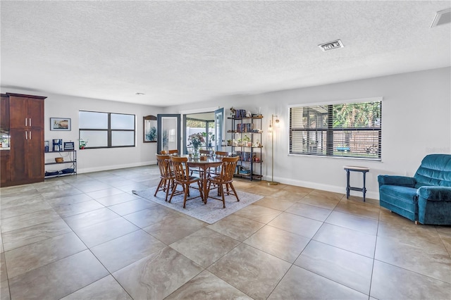 4821 S Gachet Blvd, Lakeland, FL 33813 - dining space featuring a textured ceiling and light tile patterned floors