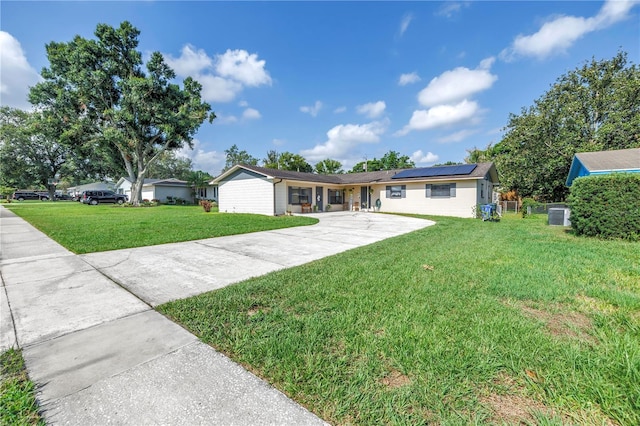 4821 S Gachet Blvd, Lakeland, FL 33813 - single story home with roof mounted solar panels, driveway, and a front lawn