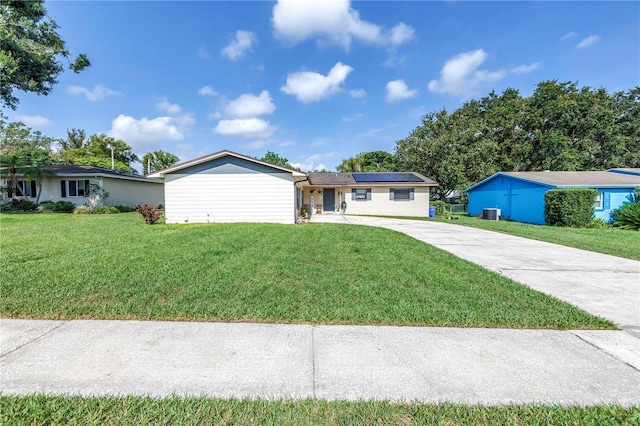 4821 S Gachet Blvd, Lakeland, FL 33813 - ranch-style house featuring driveway, roof mounted solar panels, and a front lawn