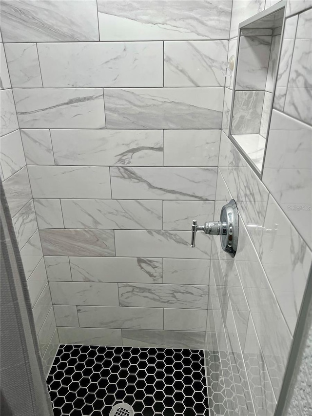 full bathroom with tiled shower