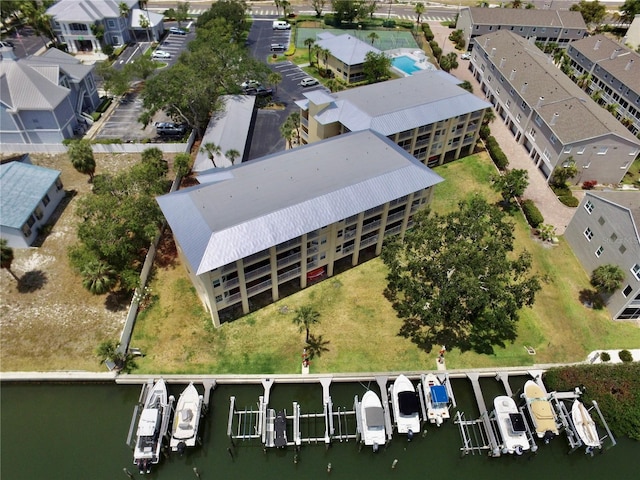 aerial view of property and surrounding area featuring a nearby body of water