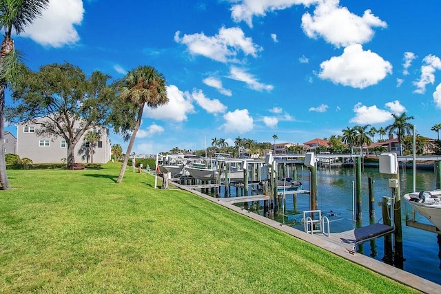 dock area featuring boat lift, a lawn, and a water view