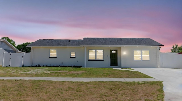 ranch-style home featuring stucco siding