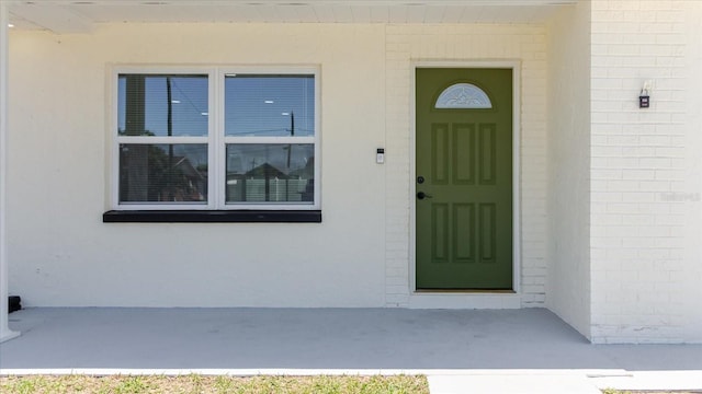 entrance to property with stucco siding