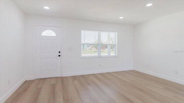 foyer featuring light wood-type flooring, recessed lighting, and baseboards