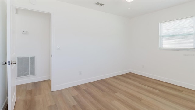 empty room with light wood-style flooring and baseboards