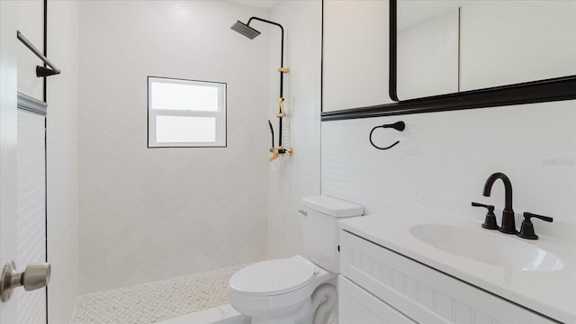 bathroom featuring a shower stall, toilet, and vanity