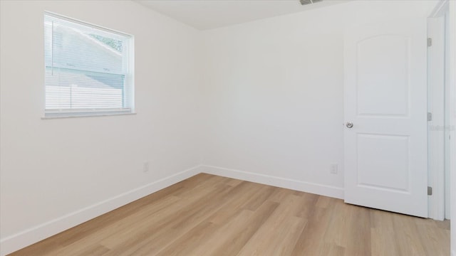 empty room with light wood-style floors and baseboards