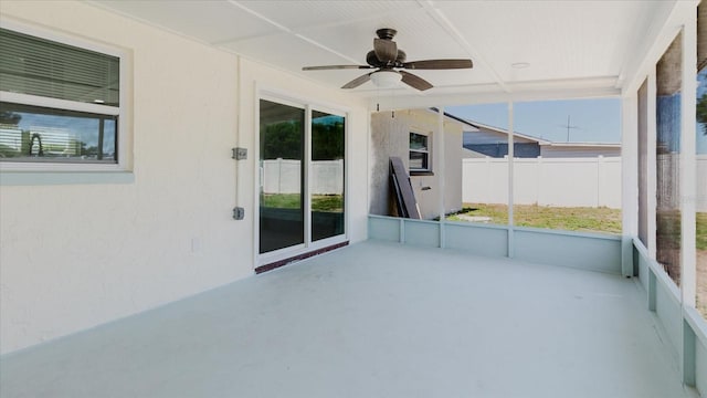 unfurnished sunroom with a ceiling fan