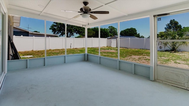 unfurnished sunroom with ceiling fan and healthy amount of natural light