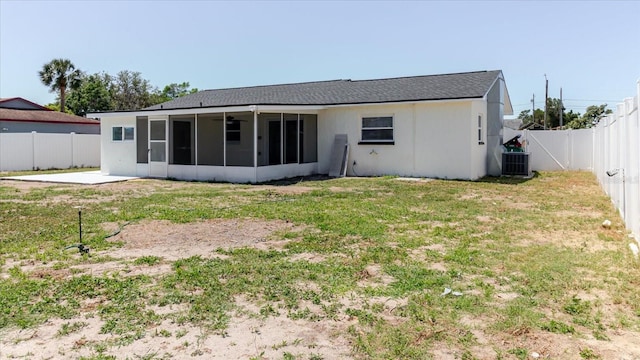 rear view of property with a sunroom, central AC, and a ceiling fan