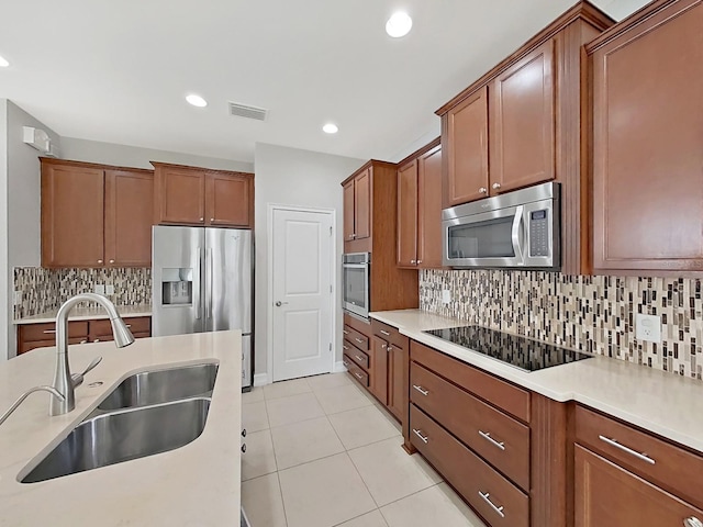 4063 Medicci Ln, Wesley Chapel, FL 33543 - kitchen with appliances with stainless steel finishes, a sink, light countertops, tasteful backsplash, and recessed lighting