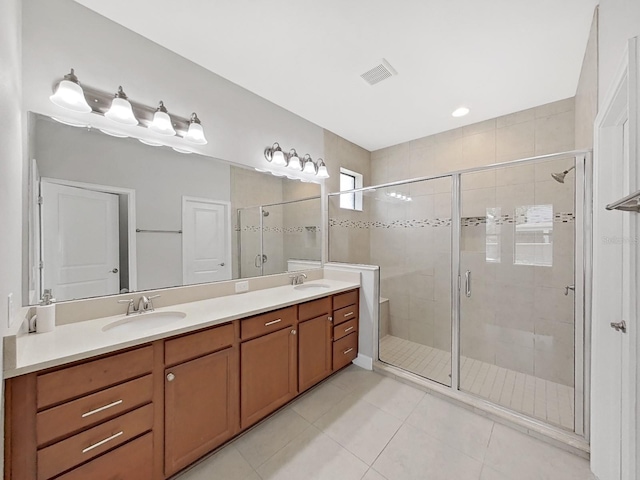 4063 Medicci Ln, Wesley Chapel, FL 33543 - bathroom featuring double vanity, tile patterned floors, and a shower stall