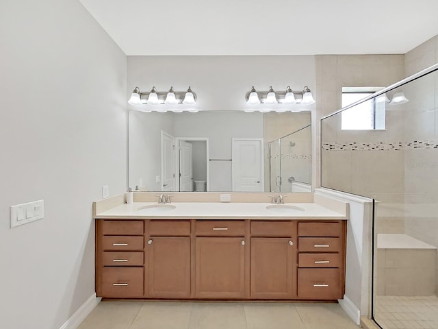 4063 Medicci Ln, Wesley Chapel, FL 33543 - bathroom featuring a stall shower, double vanity, tile patterned flooring, and baseboards