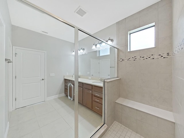 4063 Medicci Ln, Wesley Chapel, FL 33543 - bathroom with double vanity, tile patterned floors, and tiled shower