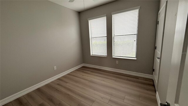 4063 Medicci Ln, Wesley Chapel, FL 33543 - unfurnished room featuring wood finished floors, baseboards, and a ceiling fan