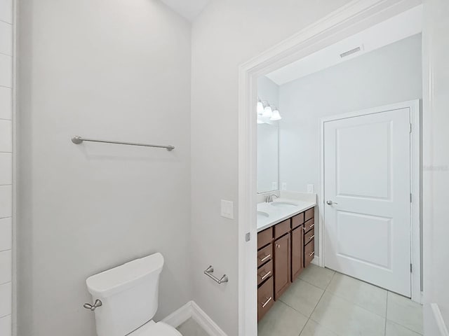 4063 Medicci Ln, Wesley Chapel, FL 33543 - bathroom with vanity, toilet, tile patterned floors, and baseboards