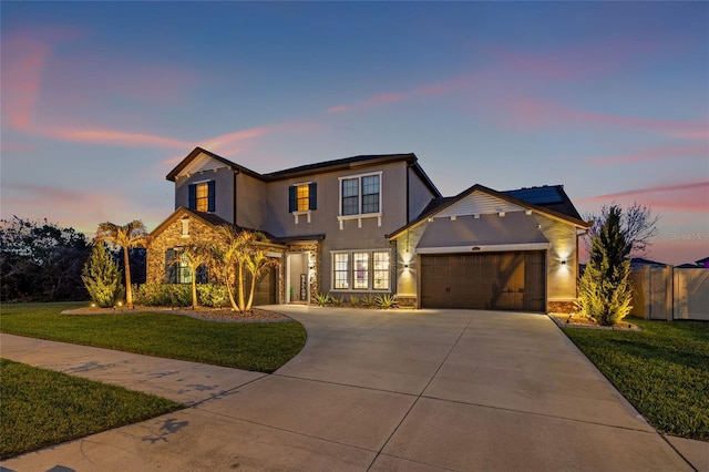 traditional home featuring stone siding, concrete driveway, solar panels, and stucco siding