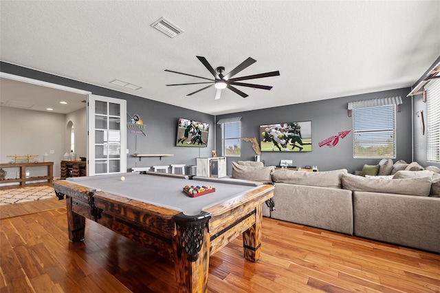 playroom featuring ceiling fan, light wood-style floors, plenty of natural light, billiards table, and a textured ceiling