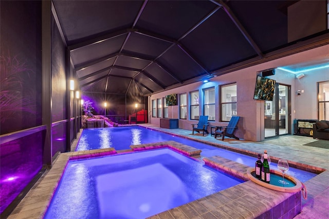 view of pool with a pool with connected hot tub