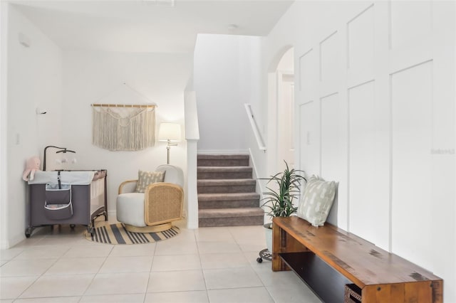 6398 Bar S Bar Trl, Zephyrhills, FL 33541 - living area featuring arched walkways, tile patterned floors, and stairway