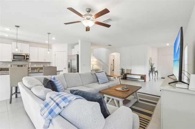 6398 Bar S Bar Trl, Zephyrhills, FL 33541 - living area with a ceiling fan, arched walkways, light tile patterned floors, and recessed lighting
