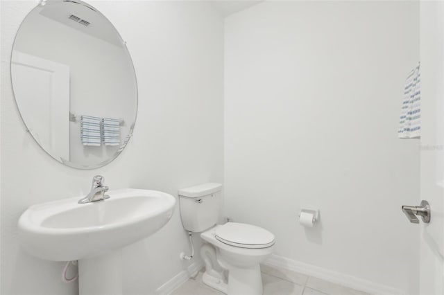 6398 Bar S Bar Trl, Zephyrhills, FL 33541 - bathroom featuring toilet, baseboards, and tile patterned flooring