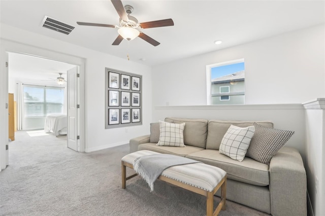 6398 Bar S Bar Trl, Zephyrhills, FL 33541 - living room featuring ceiling fan, healthy amount of natural light, carpet flooring, and baseboards
