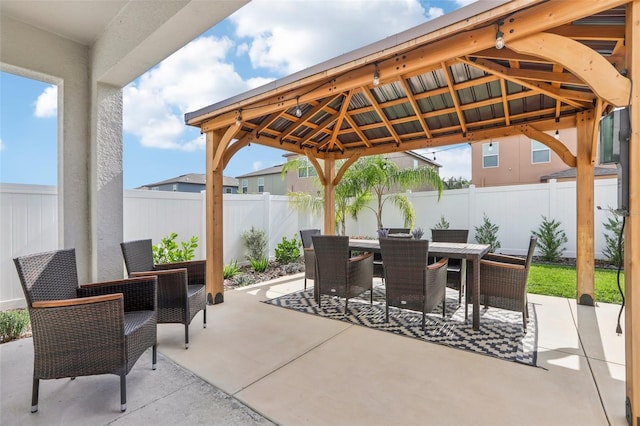 6398 Bar S Bar Trl, Zephyrhills, FL 33541 - view of patio / terrace featuring a gazebo, outdoor dining area, and a fenced backyard
