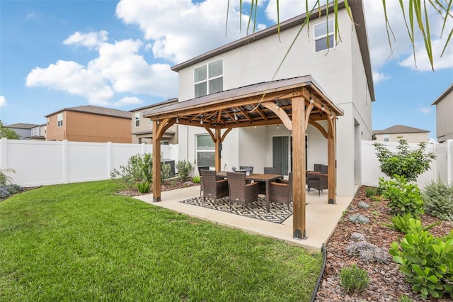 6398 Bar S Bar Trl, Zephyrhills, FL 33541 - back of property with a gazebo, stucco siding, and a patio area