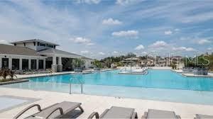 6398 Bar S Bar Trl, Zephyrhills, FL 33541 - community pool featuring a patio