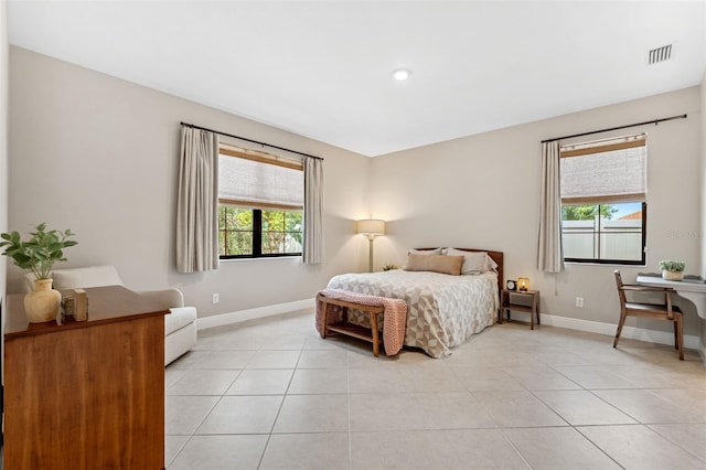3877 Burdick Loop, Odessa, FL 33556 - bedroom with multiple windows, baseboards, and light tile patterned floors