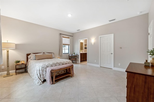 3877 Burdick Loop, Odessa, FL 33556 - bedroom featuring baseboards, light tile patterned flooring, and ensuite bath