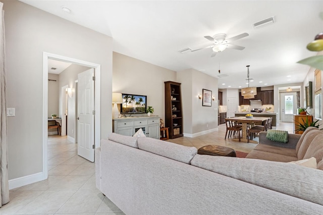 3877 Burdick Loop, Odessa, FL 33556 - living area featuring light tile patterned flooring, ceiling fan, and baseboards