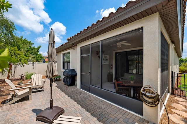 3877 Burdick Loop, Odessa, FL 33556 - view of patio / terrace featuring area for grilling, fence, ceiling fan, and a sunroom