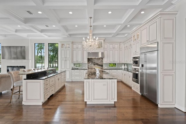 17124 Crawley Rd, Odessa, FL 33556 - kitchen featuring stainless steel built in refrigerator, a glass covered fireplace, a kitchen island, open floor plan, and recessed lighting
