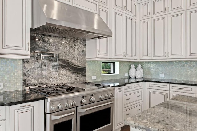 17124 Crawley Rd, Odessa, FL 33556 - kitchen featuring double oven range, under cabinet range hood, decorative backsplash, and white cabinetry