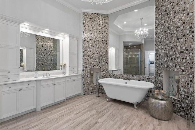 17124 Crawley Rd, Odessa, FL 33556 - bathroom with a chandelier, crown molding, a shower stall, vanity, and a soaking tub