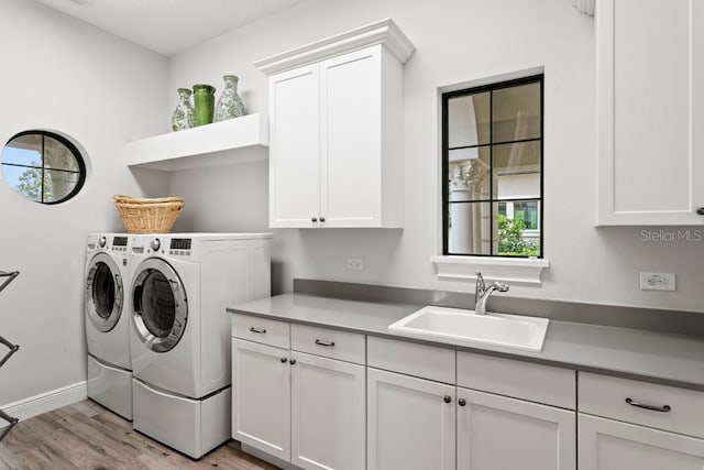 17124 Crawley Rd, Odessa, FL 33556 - laundry room with cabinet space, washer and dryer, light wood-style floors, and baseboards