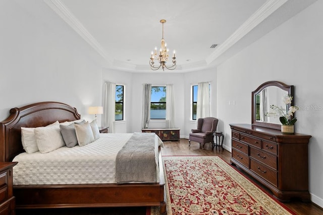 17124 Crawley Rd, Odessa, FL 33556 - bedroom featuring a chandelier, wood finished floors, a tray ceiling, baseboards, and crown molding