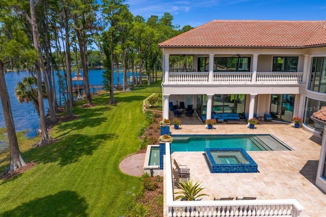 17124 Crawley Rd, Odessa, FL 33556 - back of property with a water view, a patio, a yard, a pool with connected hot tub, and a tile roof