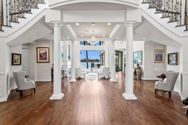 17124 Crawley Rd, Odessa, FL 33556 - foyer entrance featuring ornate columns, ornamental molding, stairs, wood-type flooring, and a water view