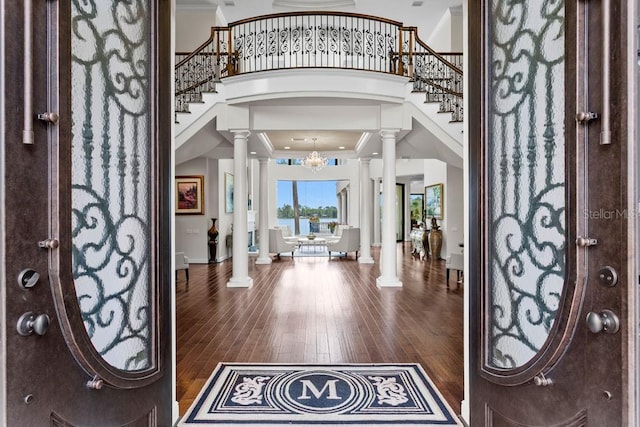 17124 Crawley Rd, Odessa, FL 33556 - entrance foyer with ornate columns, wood finished floors, stairs, a high ceiling, and ornamental molding
