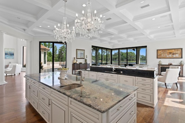 17124 Crawley Rd, Odessa, FL 33556 - kitchen with open floor plan, a sink, a large island with sink, coffered ceiling, and beamed ceiling