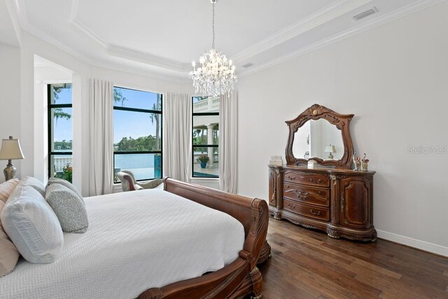 17124 Crawley Rd, Odessa, FL 33556 - bedroom featuring wood finished floors, a chandelier, ornamental molding, baseboards, and a tray ceiling